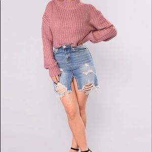 A dusty rose sweater